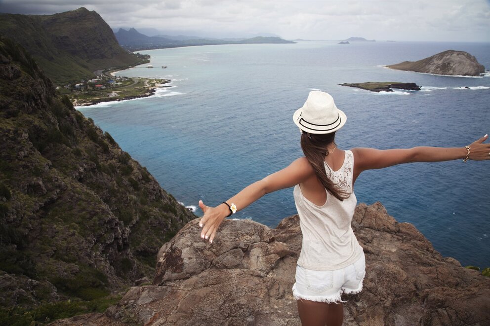 woman overlooking water on cliff