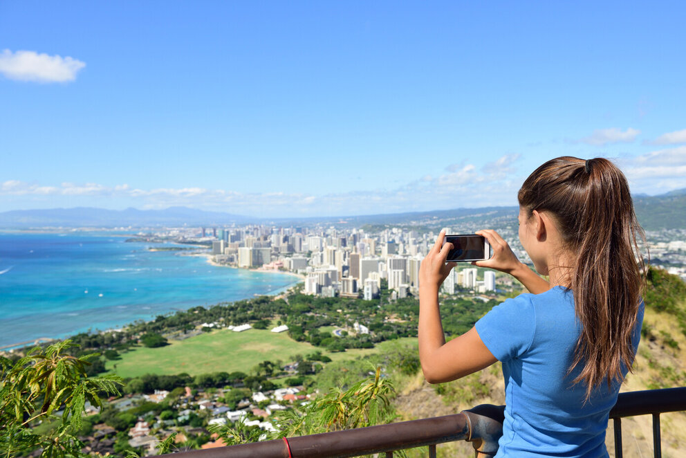 Woman taking picture of coastline