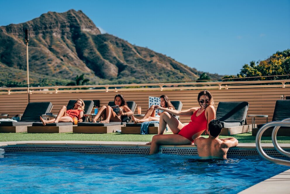People relaxing poolside