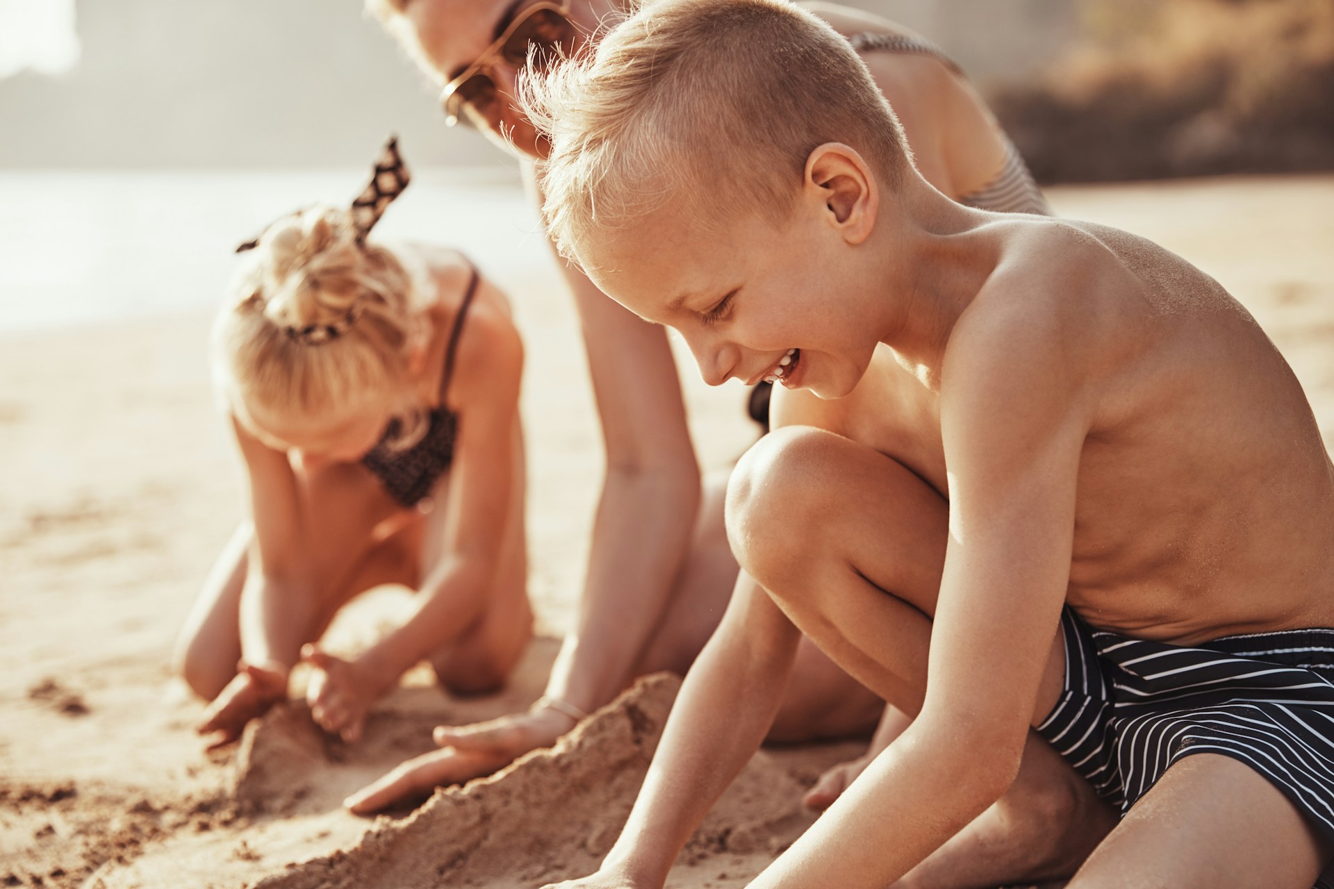 family playing with sand